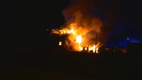 Dramatic clip of burning house with big fireballs shooting out from the house Stock Footage 92815773