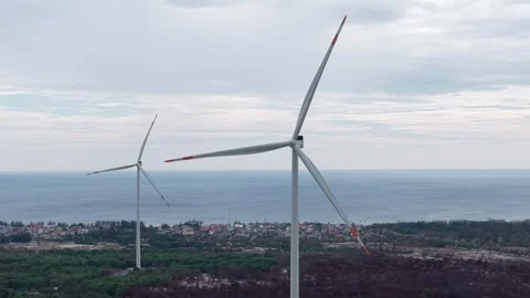 Dramatic close aerial of single wind turbine over ocean 4K Stock Footage 339862507