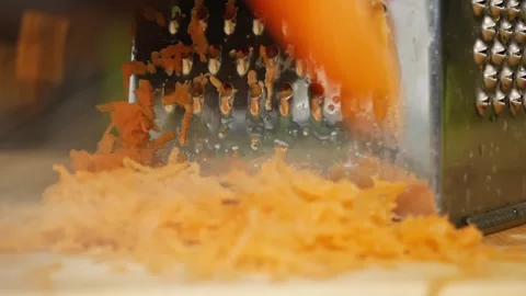 Dramatic Close-Up of Carrot Grating Stock Footage 311318393