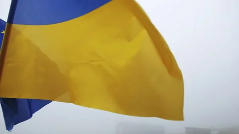 Dramatic Close up of European Union and Ukraine flags waving, Fog behind Stock Footage 246313757