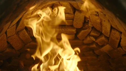 Dramatic close-up as flames lick inside of brick pizza oven, 60fps Stock Footage 123137060