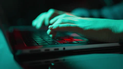 Dramatic close-up of hands typing on laptop keyboard Stock Footage 346106462