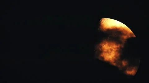 Dramatic close-up of the moon's surface with fiery orange glow Stock Footage 331500655