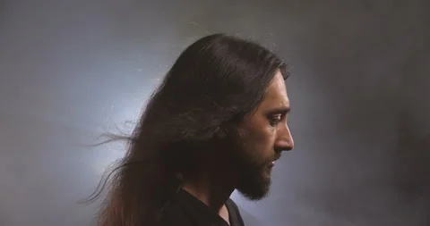 Dramatic close-up portrait of a long-haired Caucasian male Video stock 145921708