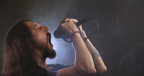 Dramatic close-up portrait of a long-haired Caucasian male 스톡 동영상 145921770