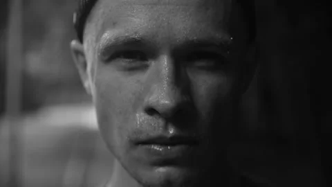 Dramatic close-up portrait of a young man's face in monochrome black and white Stock Footage 329222777