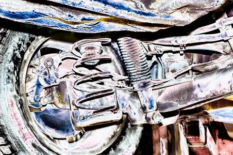 Dramatic close-up of rusty rear suspension with U-beam and shocks Stock Photos