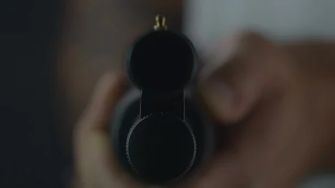 Dramatic close up shot looking down the barrel of a shotgun Stock Footage 104935477