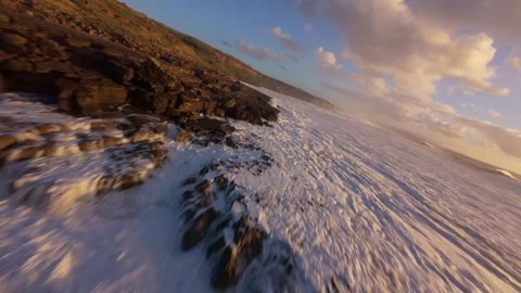 Dramatic close-up of waves hitting dark rock formations Video stock 344550607