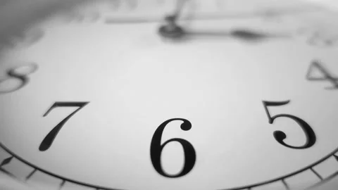 Dramatic close up of a white clock ticking. Focus on number 6. 60fps Stock Footage 139594546