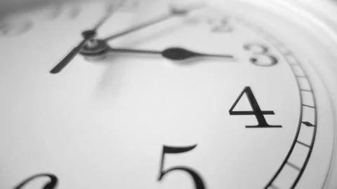Dramatic close up of a white clock ticking. Focus on number 4. 60fps Stock Footage 139594550
