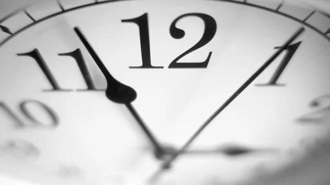 Dramatic close up of a white clock ticking. Focus on number 12. 60fps Stock Footage 139594671