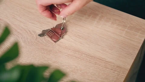 Dramatic close-up of woman hand placing house keys and wedding ring on wood.. Stock Footage 333296770