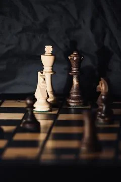 Dramatic Close-Up of Wooden Chess Pieces on a Board in Low Light Stock Photos