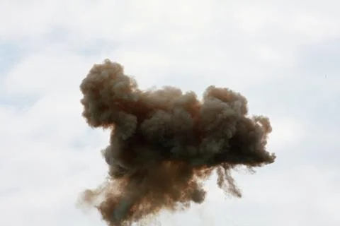 Dramatic cloud of black smoke after an explosion in the sky Stock Photos