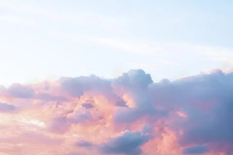 A dramatic cloud of blue, orange and pink on the blue sky in the form of a ca Stock Photos