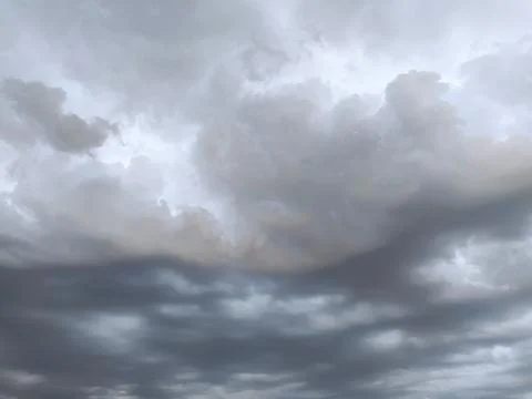 Dramatic cloud formation fills the sky during an overcast evening, hinting .. Stock Photos
