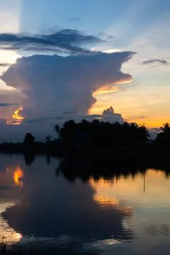 Dramatic Cloud Formation Over Water at Sunset Stock Photos