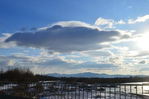 Dramatic cloud formation over a winter landscape at sunset in a rural area Stock Photos