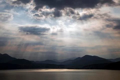 Dramatic cloud formation sunbeams behind dark clouds thunderstorm atmosphere Stock Photos