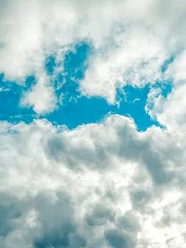 Dramatic cloud formations with bright blue sky peeking through, creating a Stock Photos