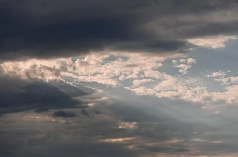 Dramatic cloud formations with sunlight breaking through in the sky Stock Photos