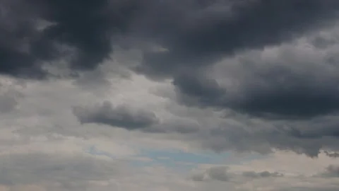 Dramatic cloud formations transition through varying shades of gray Stock Footage 321353471