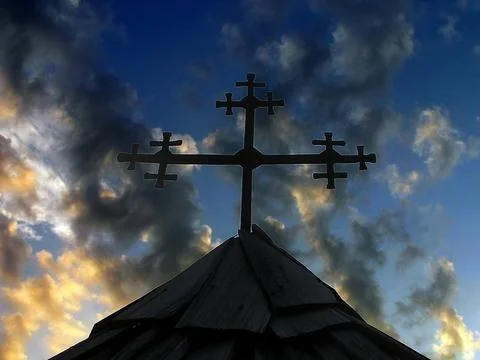 Dramatic cloud landscape and metal forged cross Stock Photos