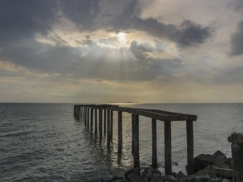 Dramatic cloud with ray over the abandoned old jetty 4K Stock Footage 80128451