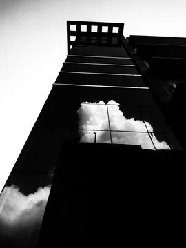 Dramatic Cloud Reflection on Modern Glass Building Facade Stock Photos