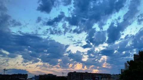 Dramatic Cloud Timelapse Over Urban Skyline at Sunset in Catalonia Stock Footage 339246048