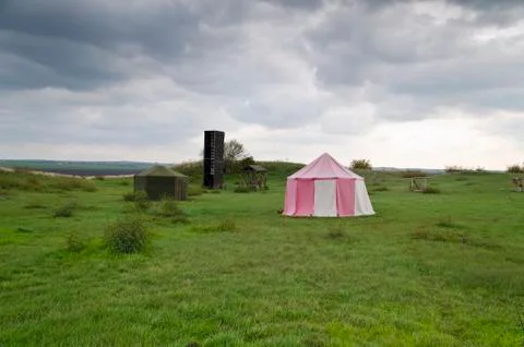 Dramatic clouds and an ancient camp, restored from medieval time Stock Photos