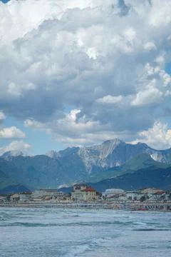Dramatic clouds and distant mountains tower over the city of Viareggio Stock Photos