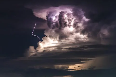 Dramatic clouds and lightning in a thunderous sky in asia. Fotos Stock