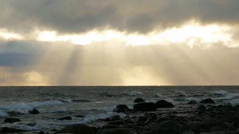Dramatic clouds and rays of light shining over the ocean Stock Footage 98370392