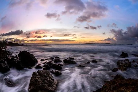 Dramatic clouds and sky at sunset in hawaii on the beach Stock Photos