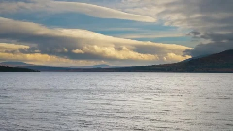 Dramatic Clouds and Stormy Sky Reflected in Calm Lake Water Stock Footage 325467673