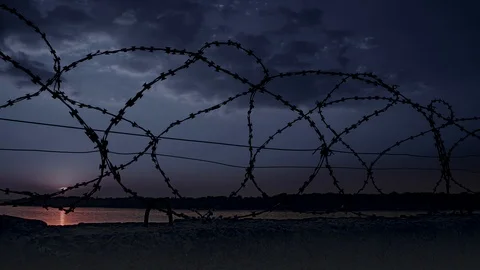 Dramatic clouds behind barbed wire fence 2 Video stock 94049517