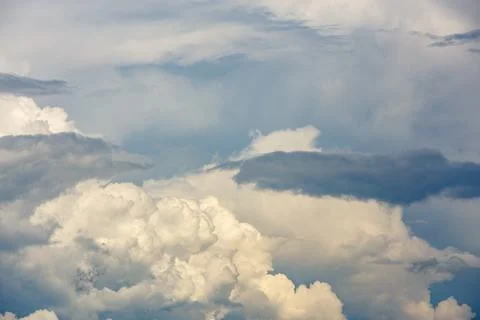 Dramatic clouds in blue sky during daytime outdoors Stock Photos