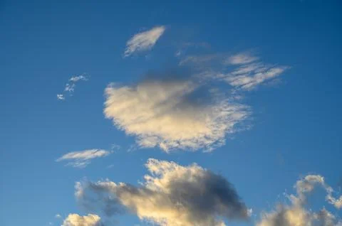 Dramatic clouds in a blue sky at sunset Stock Photos