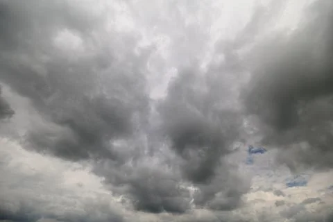 Dramatic clouds cast shadows over the landscape on a cloudy day Stock Photos