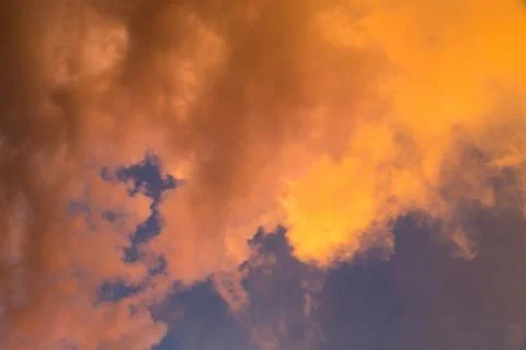 Dramatic clouds at colourful moody sunset Stock Photos