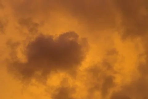 Dramatic clouds at colourful moody sunset Stock Photos