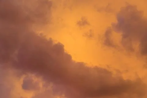 Dramatic clouds at colourful moody sunset Stock Photos