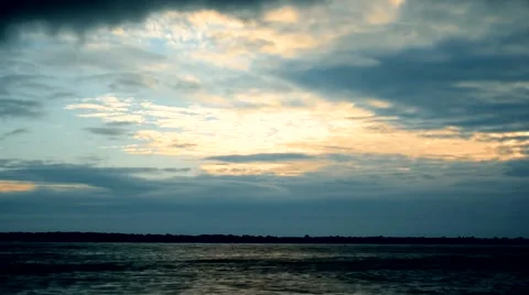 Dramatic clouds at dawn over river or lake Stock Footage 67877606