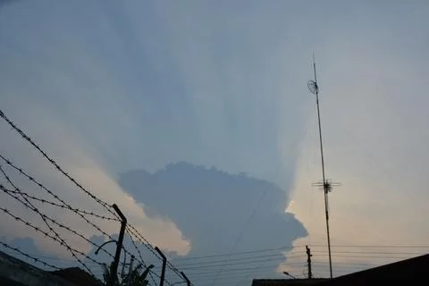 Dramatic clouds in the eastern sky with the sun rises behind it Stock Photos