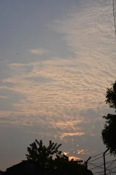 Dramatic clouds in the eastern sky with the sun rises behind it Stock Photos