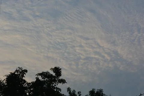 Dramatic clouds in the eastern sky with the sun rises behind it Stock Photos