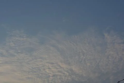 Dramatic clouds in the eastern sky with the sun rises behind it Stock Photos