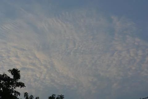 Dramatic clouds in the eastern sky with the sun rises behind it Stock Photos